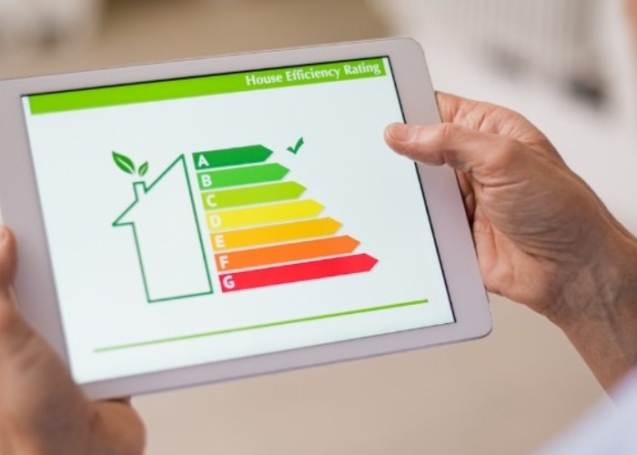 Heating Efficiency A person is reviewing a home energy rating on a tablet.