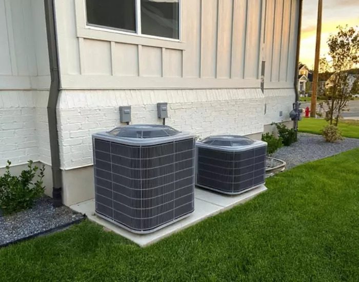 Two air conditioners outside a house, possibly for an AC upgrade system.