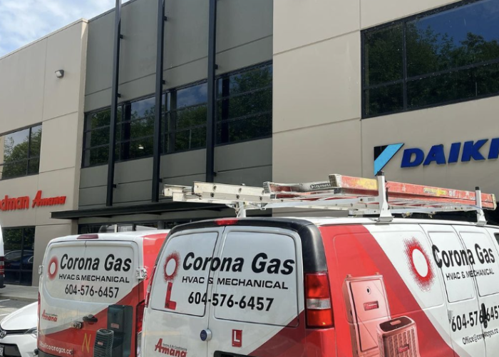 Two Corona Gas vans parked in front of a building with the company's contact information.