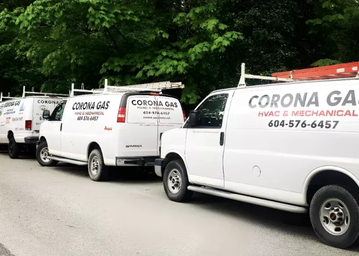 A row of Corona Gas Vans parked on the side of the road.